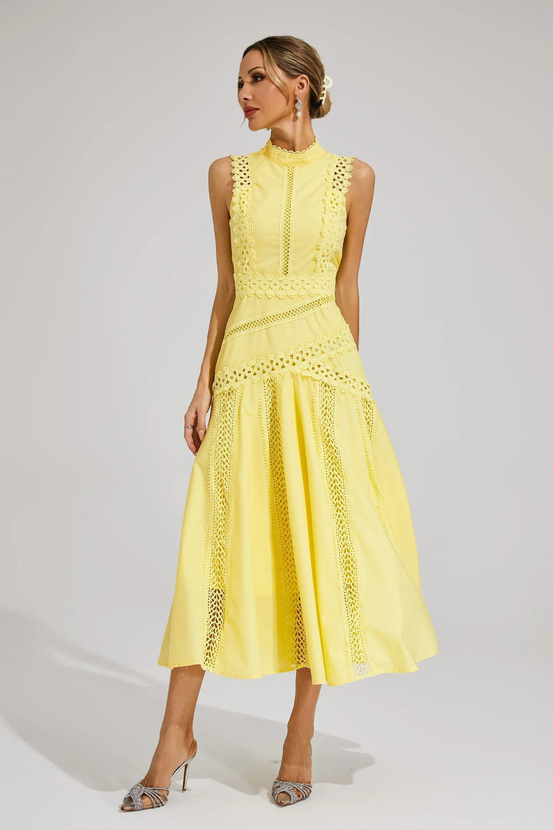 Close-up of the delicate lace panel and high neck on an elegant women's sleeveless flared midi dress for summer.