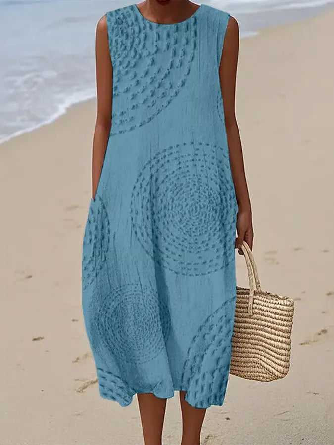 Women's elegant sleeveless midi dress featuring intricate embroidery and a flattering flowy A-line silhouette.