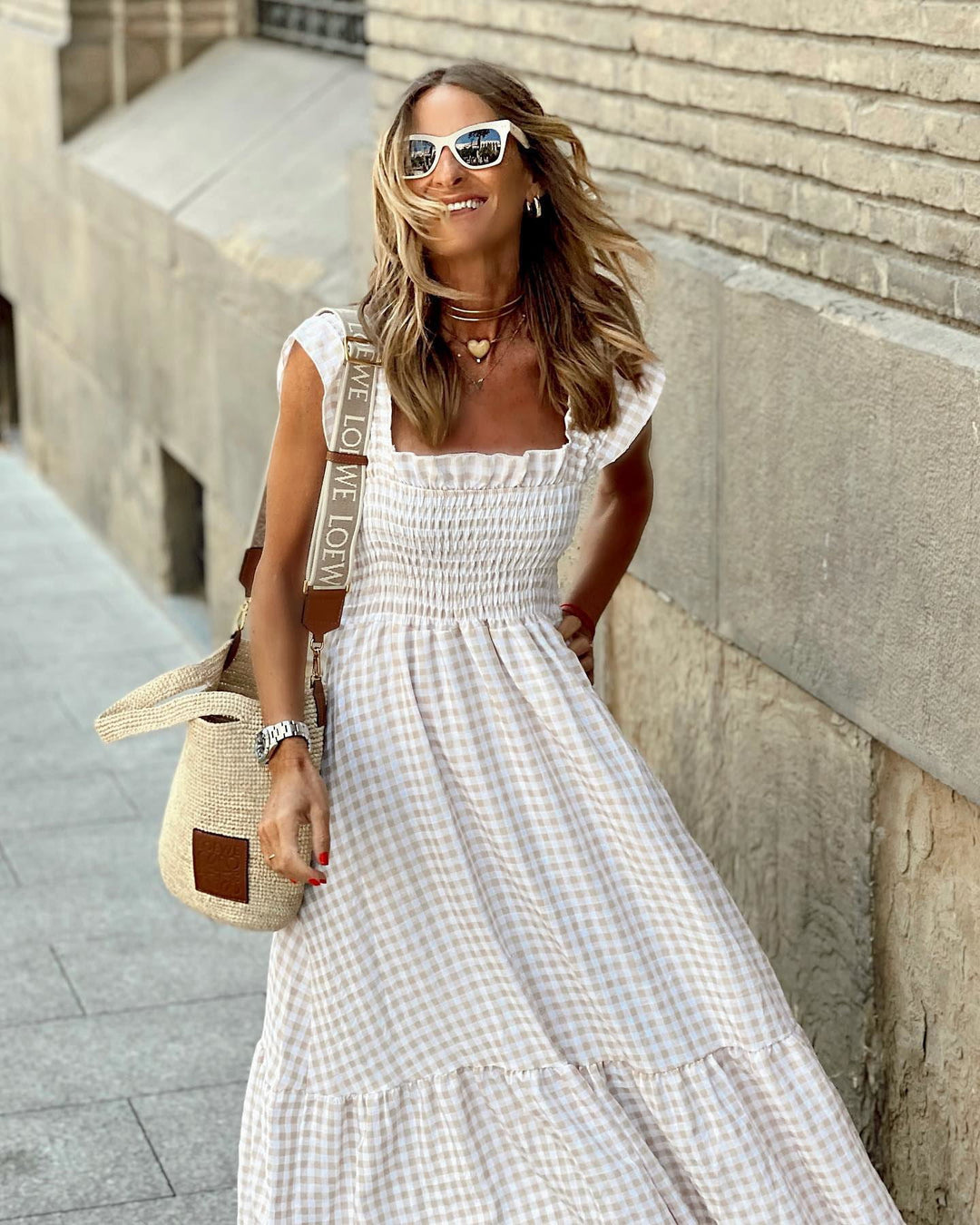 Fashionable women's square neck maxi dress with elegant ruffle sleeves and a flowing tiered silhouette.