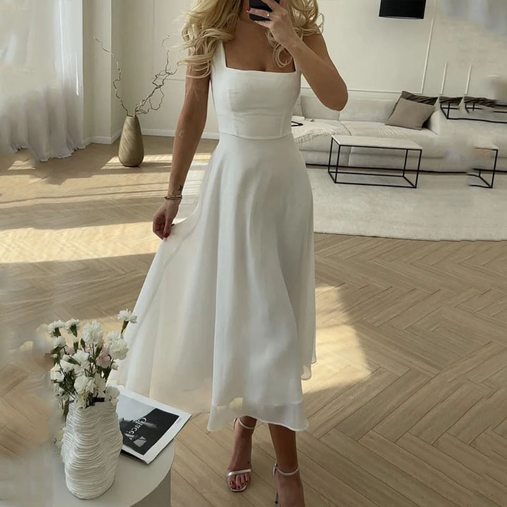 Chic women's midi dress with square neck. Elegant sleeveless design, ideal for wedding guests & formal events.