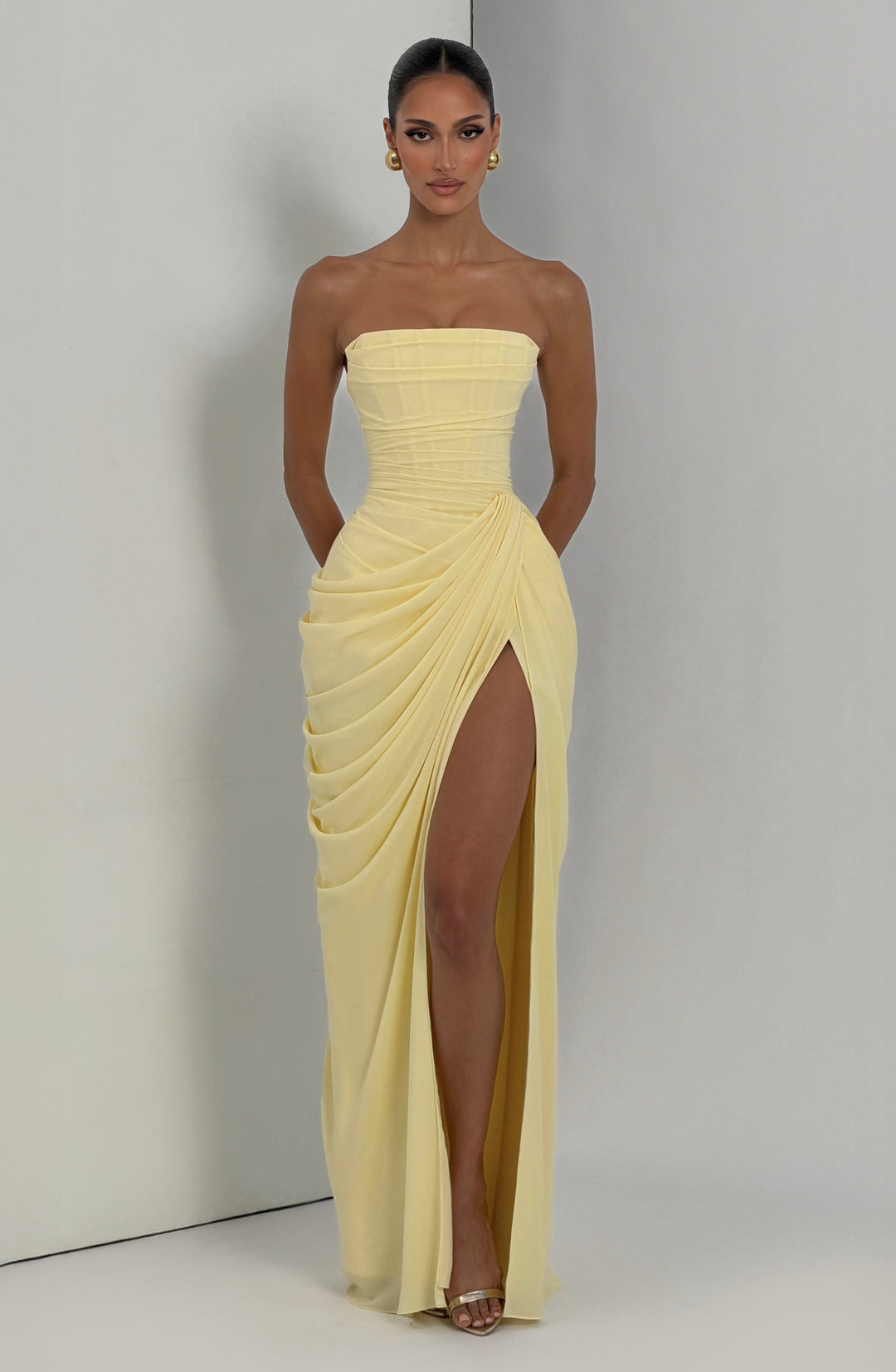 Women's long party dress, strapless style with a detailed corset top and a smooth, elegant column skirt.