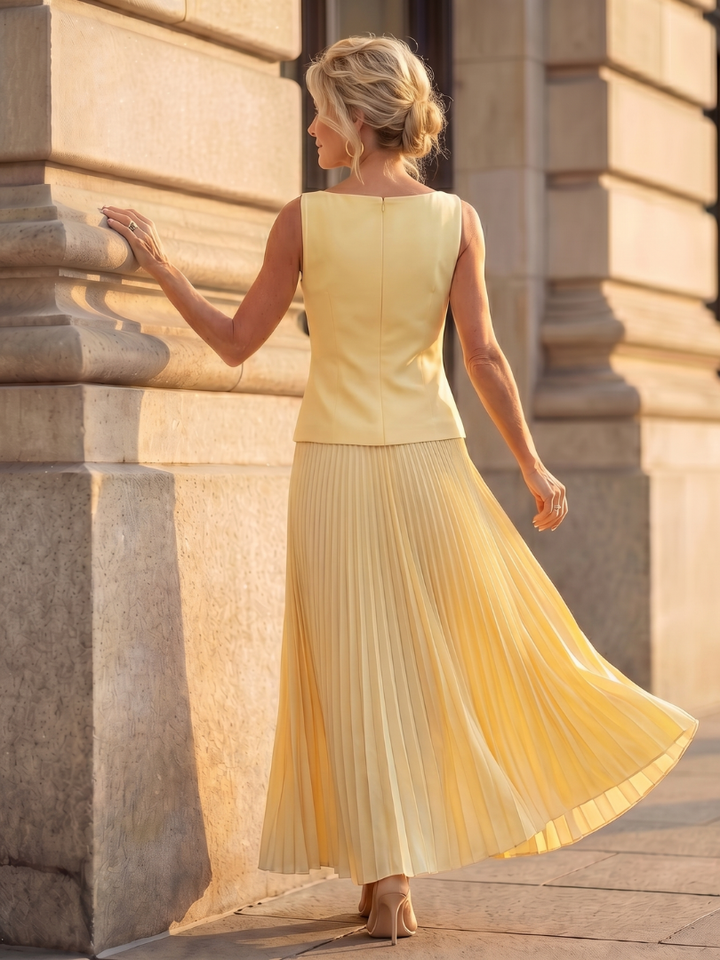 Modest yet stylish women's ensemble: structured sleeveless top and elegant pleated maxi skirt.
