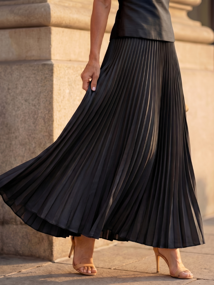 Sophisticated women's pleated maxi skirt set with a chic structured sleeveless top.