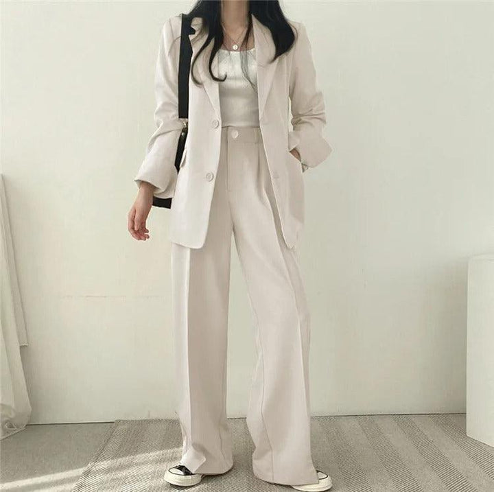 Dressy women's suit: long tailored blazer paired with refined matching trousers