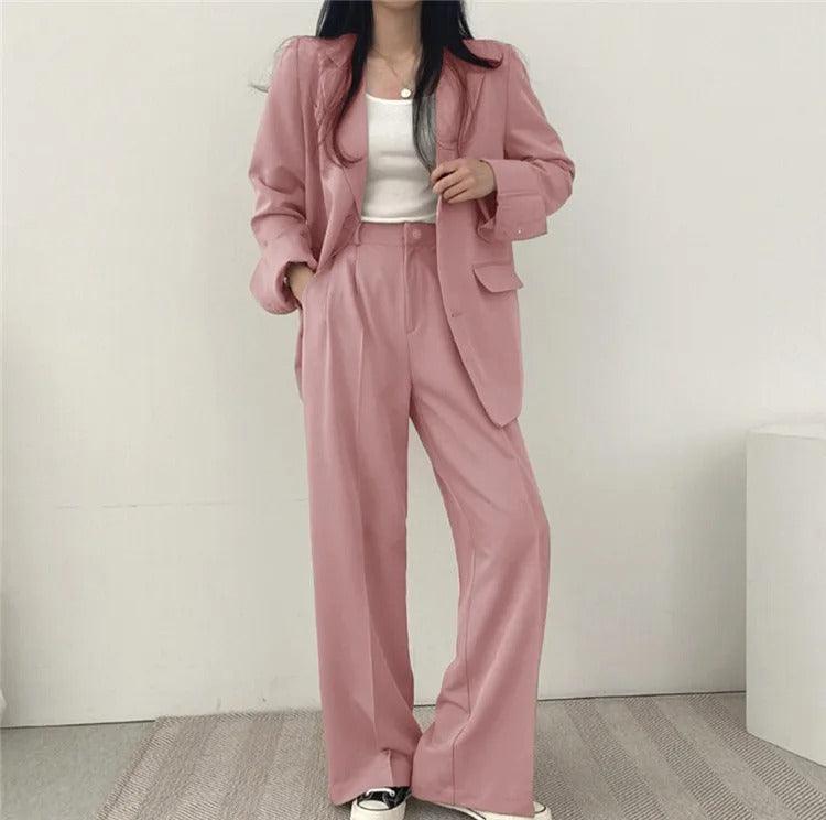 Formal attire women's suit featuring a stylish long tailored blazer and trousers