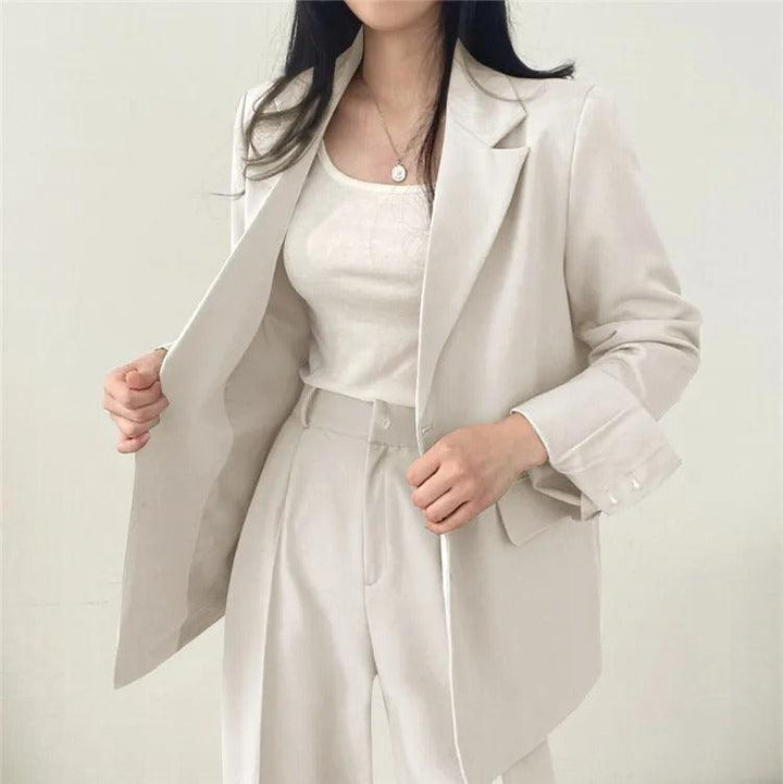 Stylish women's long blazer and tailored trousers creating a modern power suit