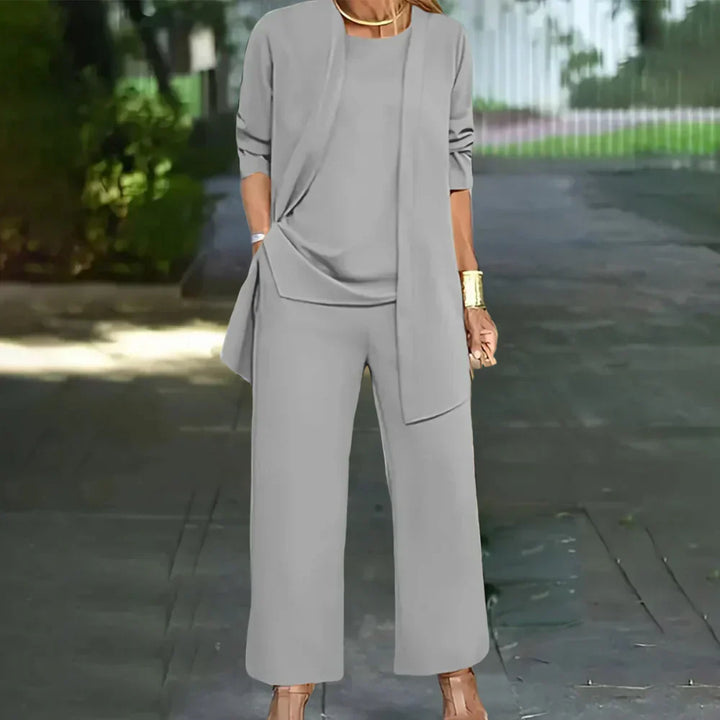 Stylish women's tailored three-piece suit. Includes a fitted blazer, matching vest, and straight-leg pants.