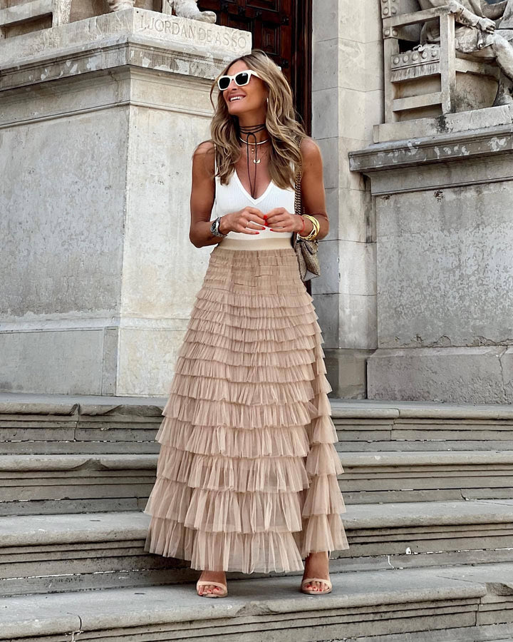 Elegant women's tiered maxi skirt with ruffled layers, perfect for evening wear.