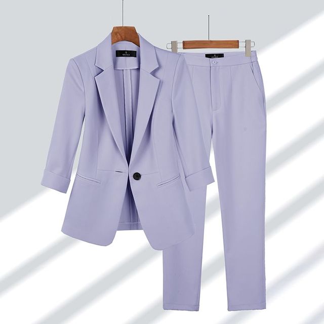 Elegant women's two-piece blazer and pants set for professional office wear. Stylish business casual coordinated outfit.