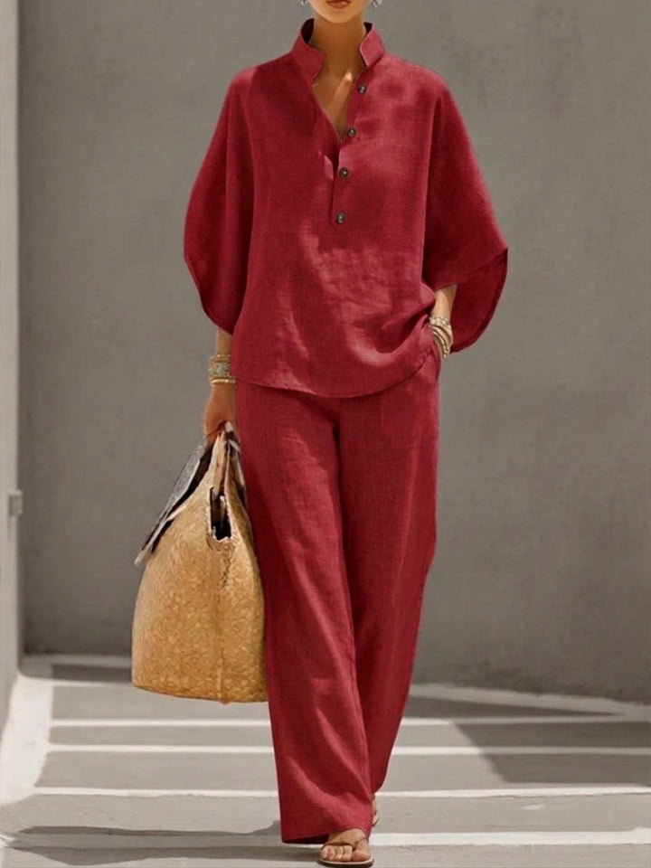 Women's elegant batwing sleeve blouse and wide-leg trousers two-piece set, ideal for sophisticated casual wear.