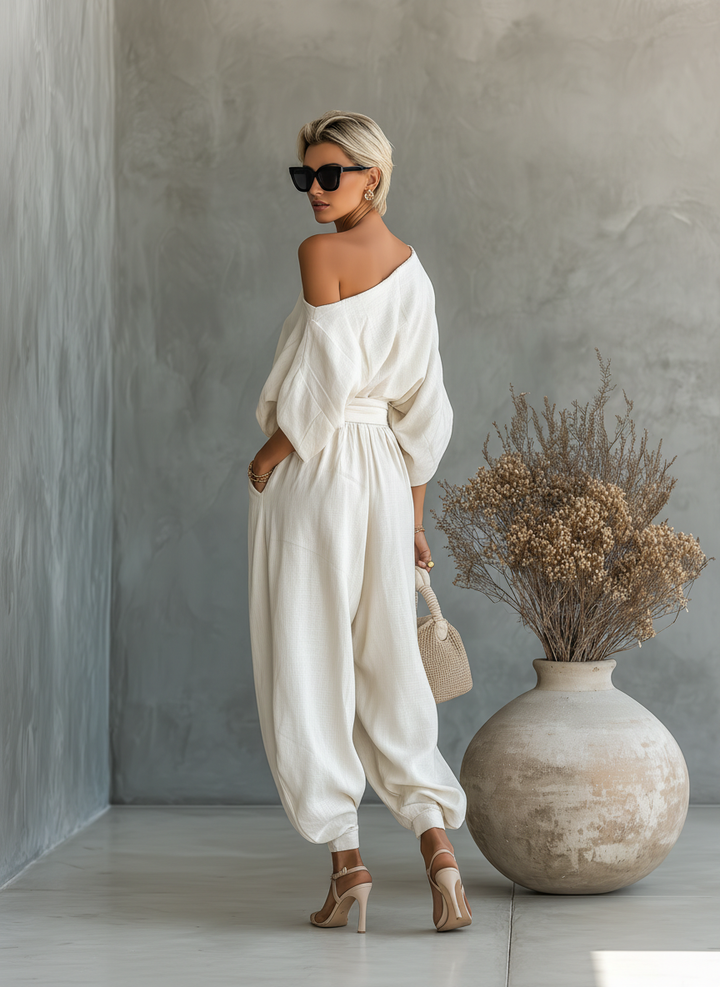Women's elegant resort wear: asymmetric drape top with comfortable elastic waist wide leg pant coordinated set.