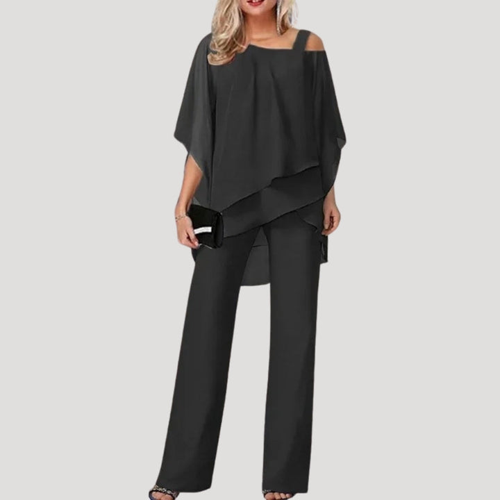 Stylish women's two-piece set, wide leg trousers & asymmetric top. Ideal elegant attire for summer events.