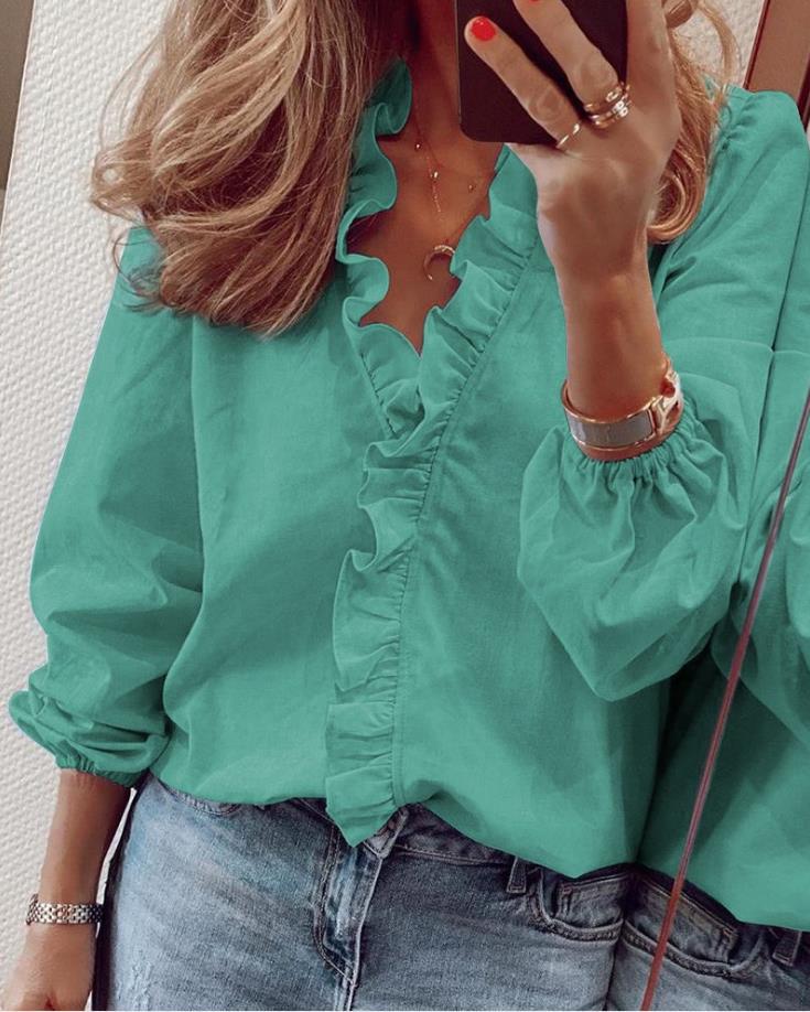 Fashionable women's V-neck blouse with elegant ruffles. A stylish and versatile top for any occasion.