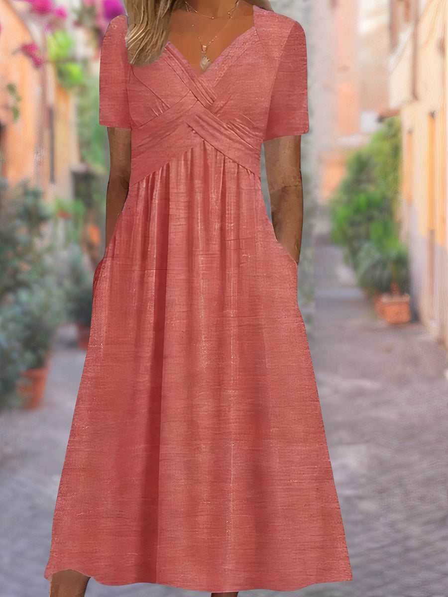 Close-up of the elegant V-neck and crisscross bodice on a women's flowing midi dress, showcasing detail.