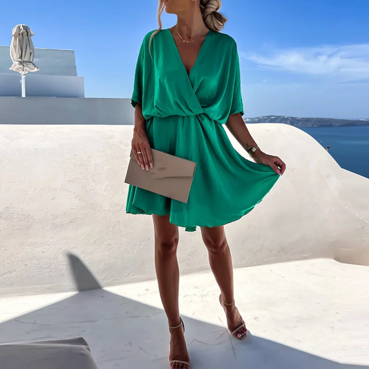 Chic women's skater-style V-neck flowy wrap mini dress. Perfect for a sophisticated summer party or resort.