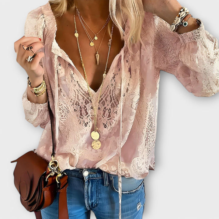 Romantic women's V-neck long sleeve blouse featuring intricate lace detailing, great for evening or day wear.