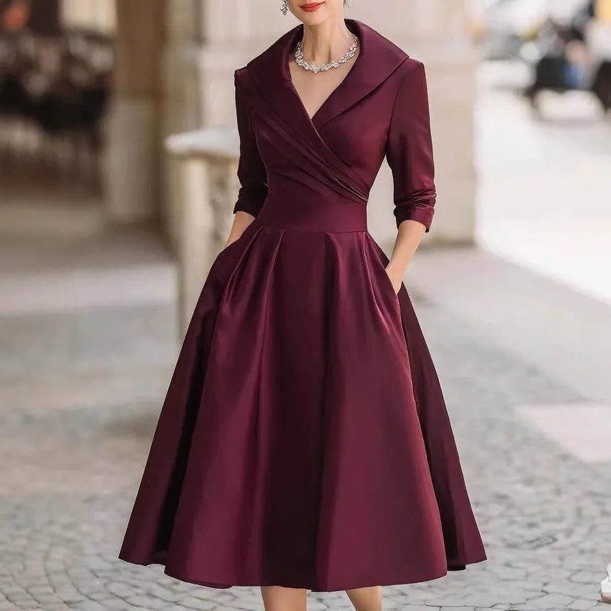 Comfortable black V-neck midi dress for women, featuring three-quarter sleeves and a flattering flared skirt for all-day elegance.