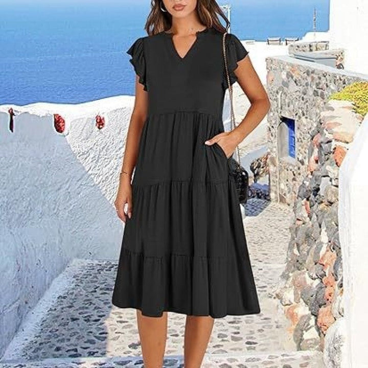 Stylish women's V-neck midi dress with flutter sleeves, tiered skirt & pockets. Comfortable & versatile.