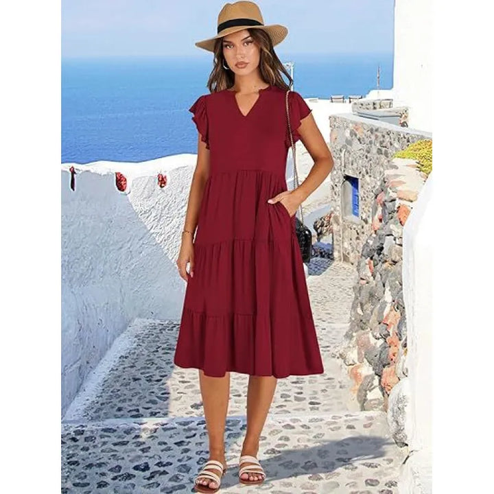 Chic women's tiered V-neck midi dress with soft flutter sleeves. Fashionable & comfortable for spring/summer.