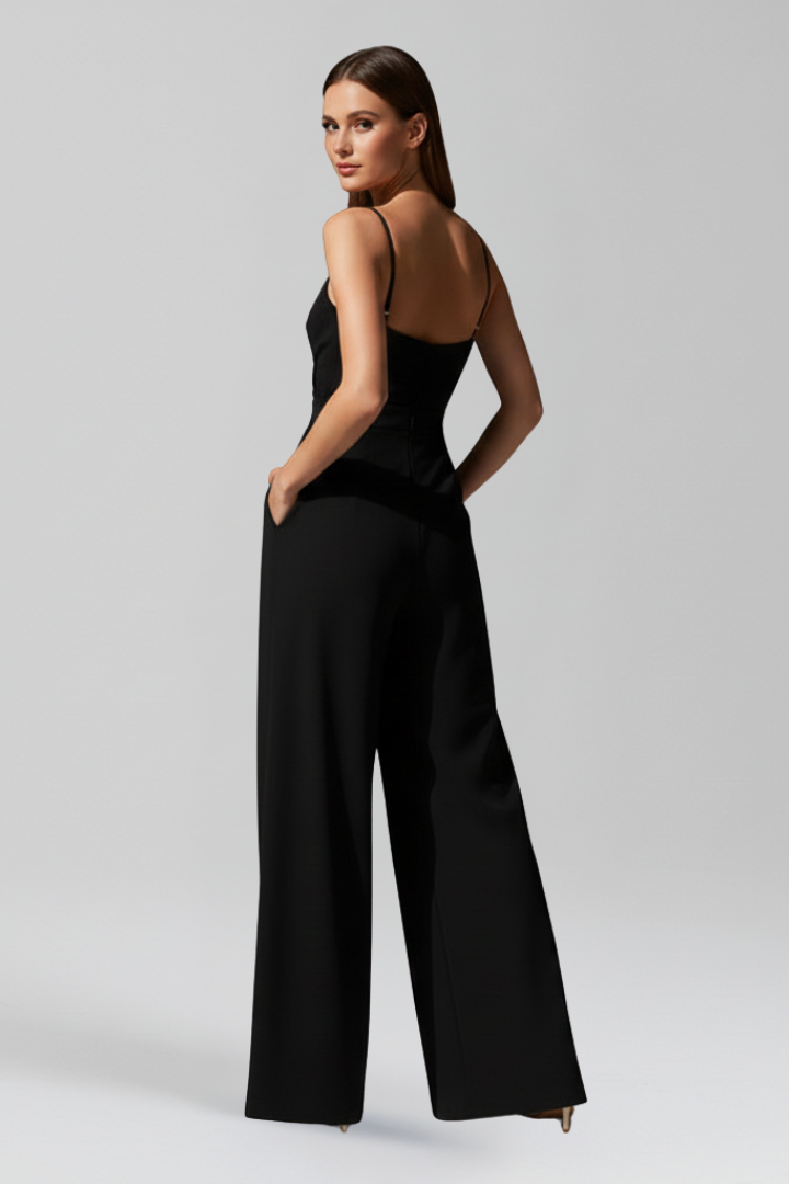 Green women's V-neck wide leg jumpsuit. Chic sleeveless style, perfect for elegant summer fashion.
