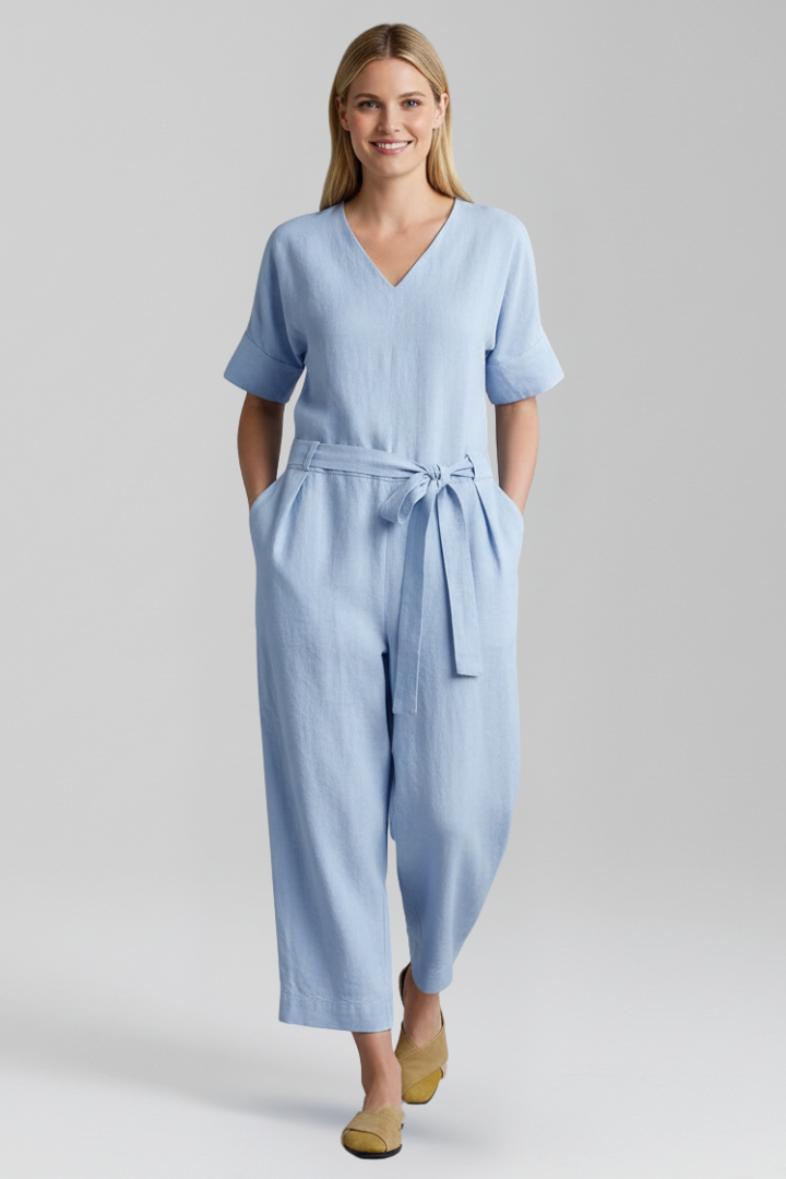 Elegant women's wide-leg jumpsuit with V-neckline, long sleeves, and a defined waist tie for a refined look.