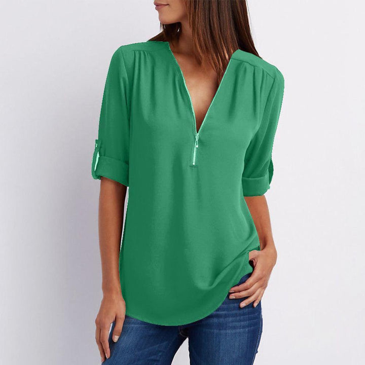 Full shot of a women's elegant long sleeve blouse, V-neck with zipper and subtle patchwork detail