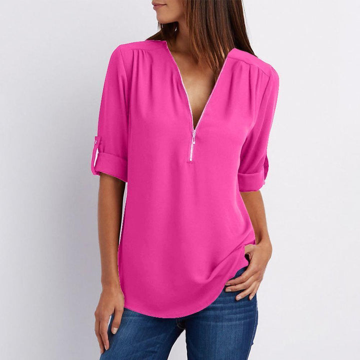 Detail of the zipper and patchwork on a women's V-neck chiffon long sleeve top, elegant style