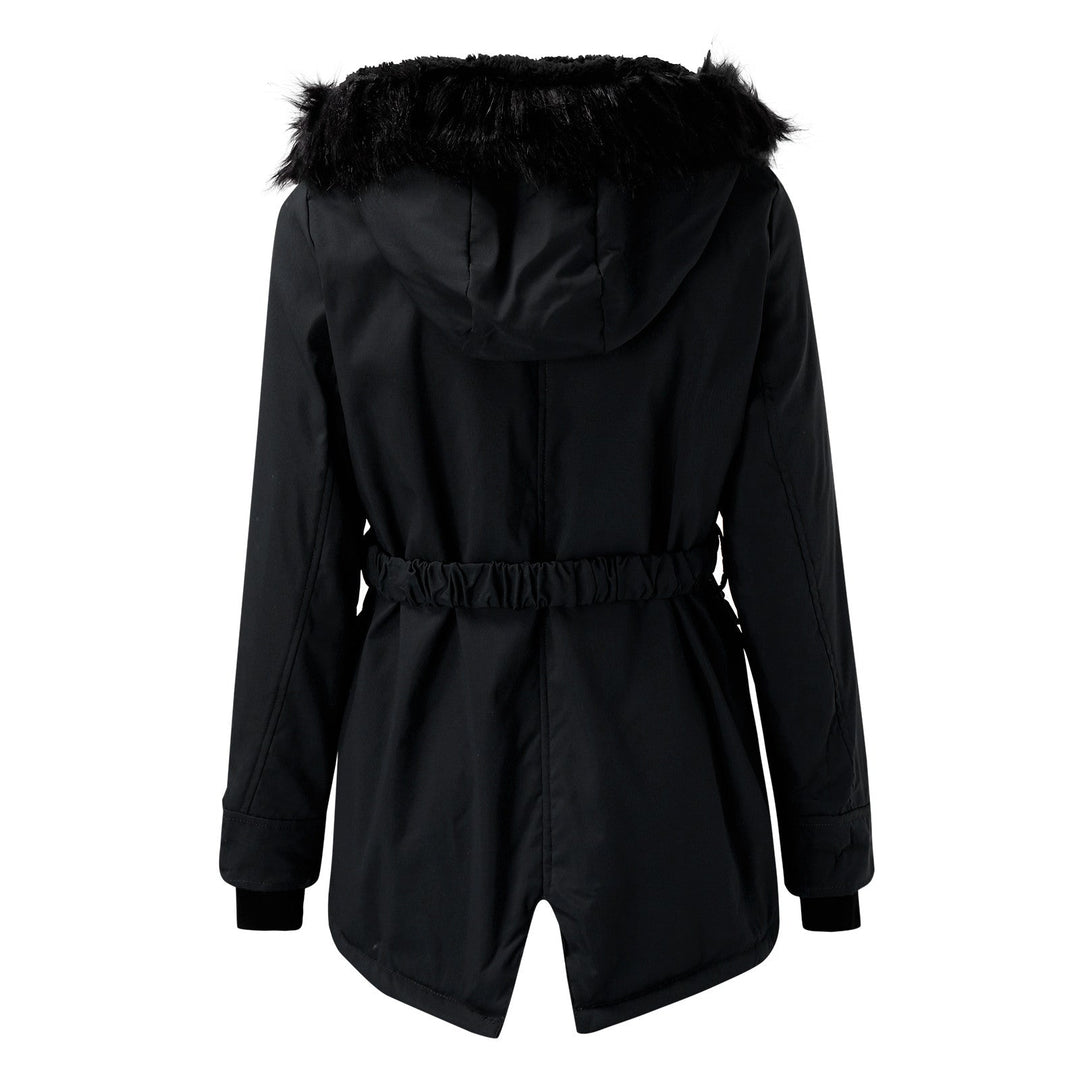 Folded warm women's winter coat with faux fur hood, ready for cold outdoor adventures.