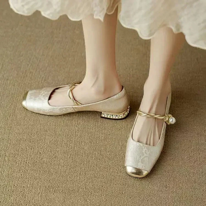 Women's ballet flats in a chic design with pearls and a contrasting metallic toe.