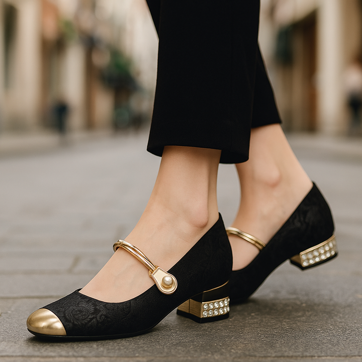 Close-up of pearl embellished women's ballet flats with a shiny gold metallic accent.