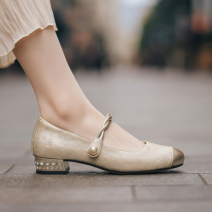Orthopedic women's dress flats featuring pearls and a sleek metallic detail, front view.