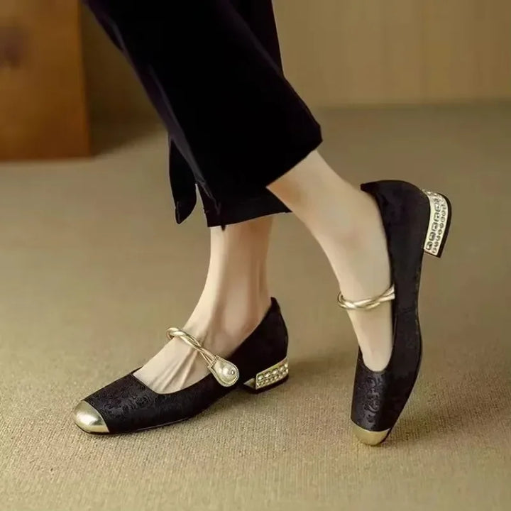 Fashionable women's flats with pearl detailing and a shimmering metallic cap-toe.