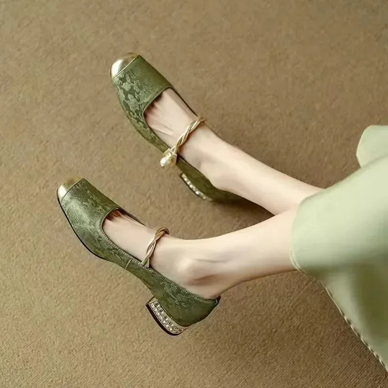 Top-down view of sophisticated women's pearl flats with eye-catching metallic embellishment.