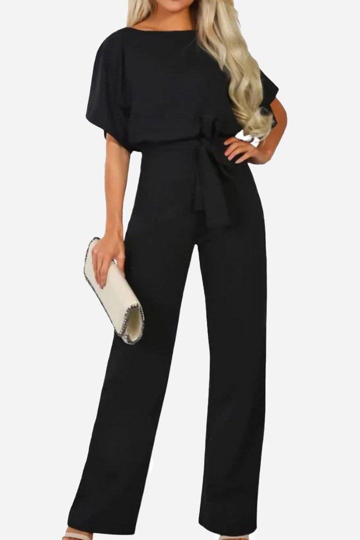 Elegant women's wide-leg jumpsuit with batwing sleeves and belt, perfect for versatile day-to-night styling.
