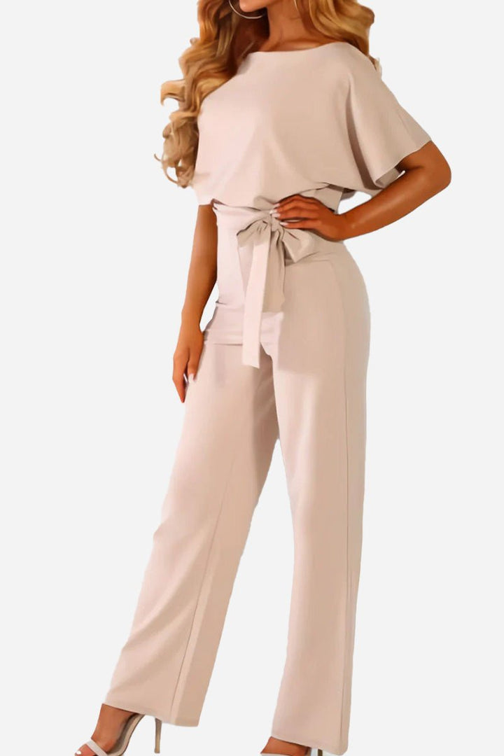 Stylish and comfortable women's wide-leg jumpsuit. Features batwing sleeves, belted waist, and relaxed fit.