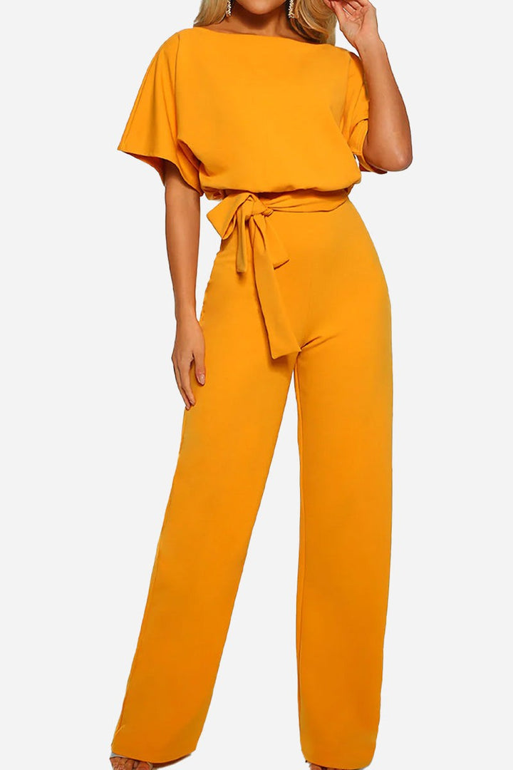 Chic women's elegant wide-leg jumpsuit with batwing sleeves. Belted design offers versatile day-to-night fashion.
