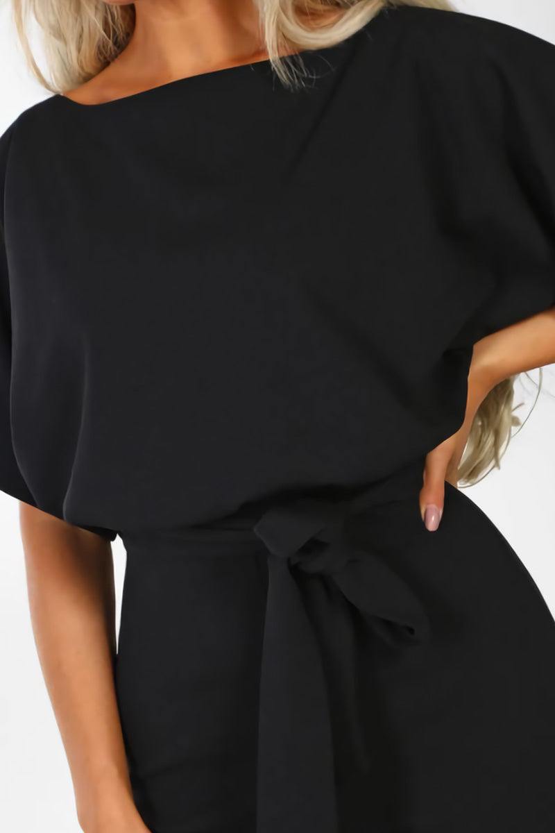 Relaxed fit women's elegant wide-leg jumpsuit. Comfortable one-piece with chic batwing sleeves and belted waist.