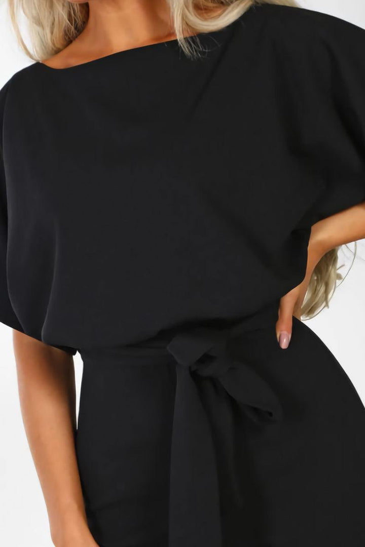 Relaxed fit women's elegant wide-leg jumpsuit. Comfortable one-piece with chic batwing sleeves and belted waist.