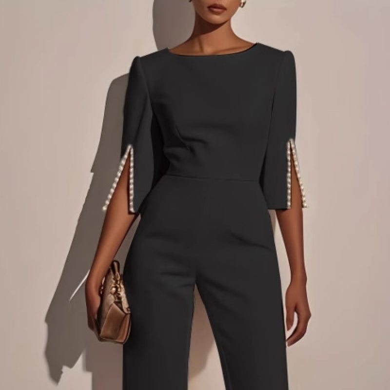 Women's elegant wide leg jumpsuit. Pearl-detailed sleeves add a touch of glamour to this versatile spring fashion piece.