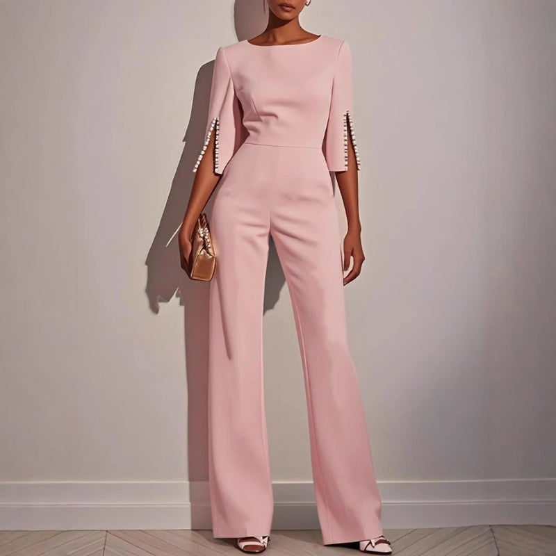 Stylish women's wide leg jumpsuit with intricate pearl sleeve detail, perfect for summer parties or an elegant brunch.