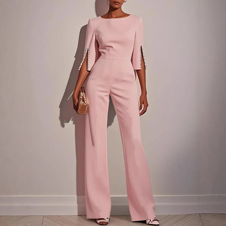 Stylish women's wide leg jumpsuit with intricate pearl sleeve detail, perfect for summer parties or an elegant brunch.