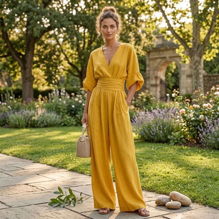 Elegant women's wide leg jumpsuit with cinched waist & V-neck, perfect for day or night versatile fashion.