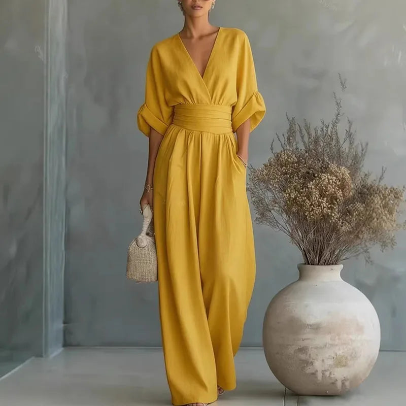 Sophisticated wide leg women's jumpsuit with a cinched waist & V-neck, perfect for elegant evening wear.