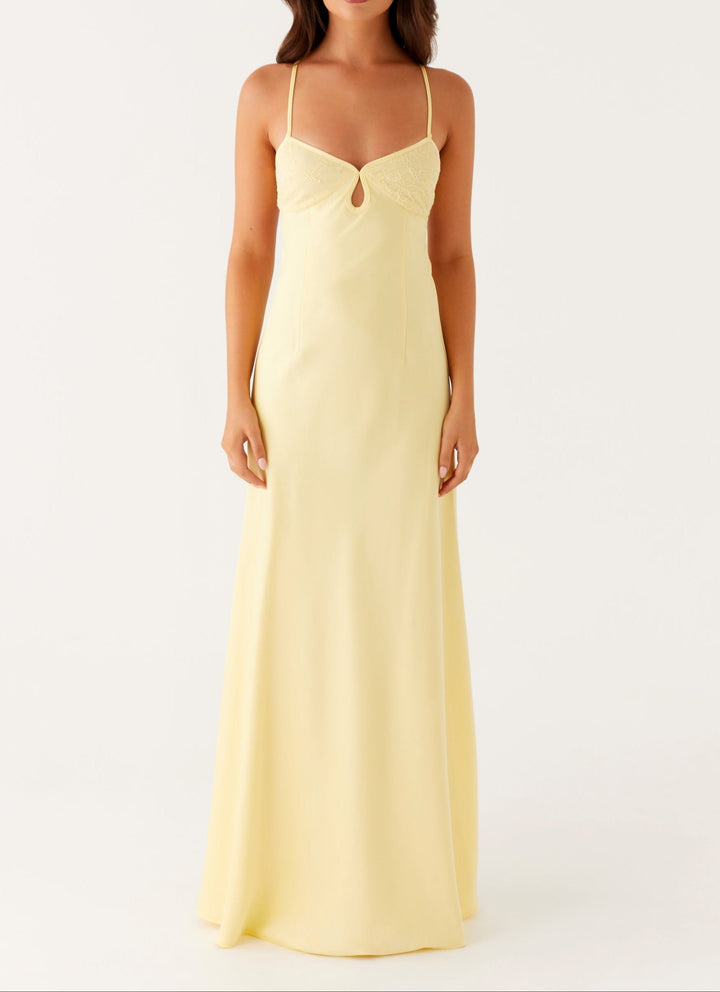 Vibrant yellow halterneck maxi dress for women, ideal for elegant celebrations & summer events.