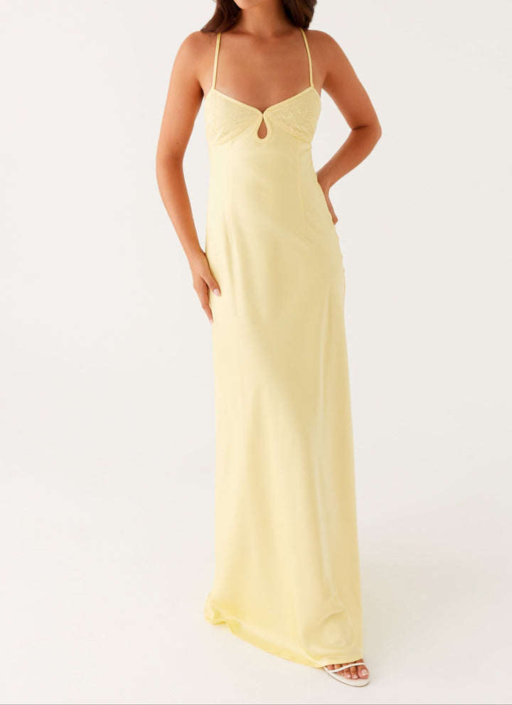 Stylish women's yellow halterneck maxi dress, versatile for formal events, summer or evening wear.