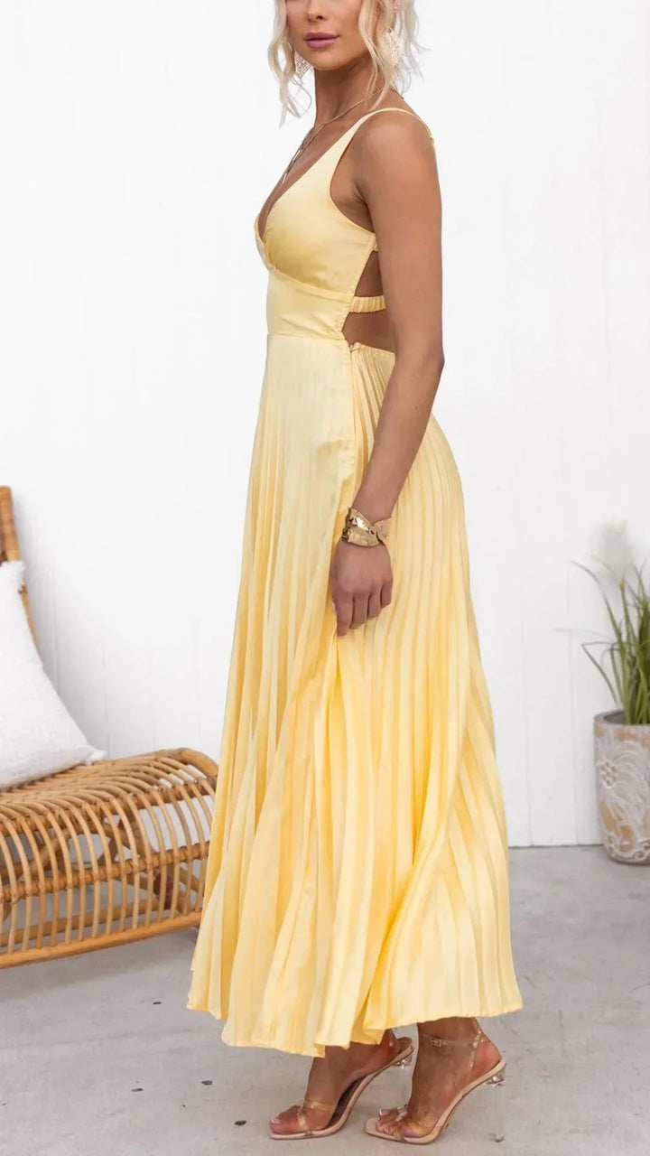 Full shot of a model wearing a long yellow pleated V-neck summer dress