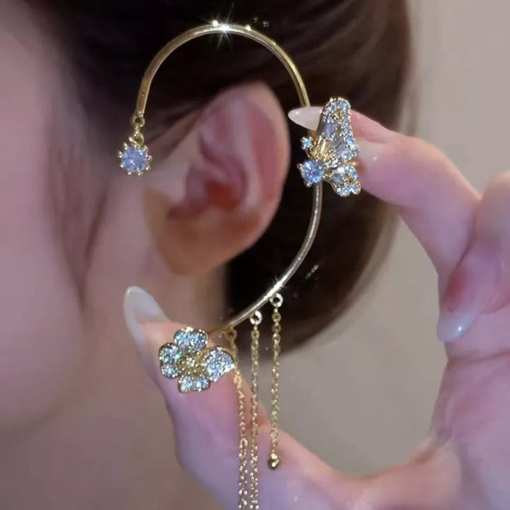 Close-up of women's fashion jewelry: sparkling zircon butterfly earrings with delicate dangle.