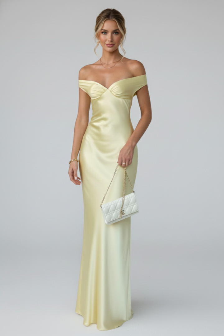 Chic women's off-shoulder maxi dress, fitted bodice, long flowing skirt. Ideal for summer parties & elegant occasions.