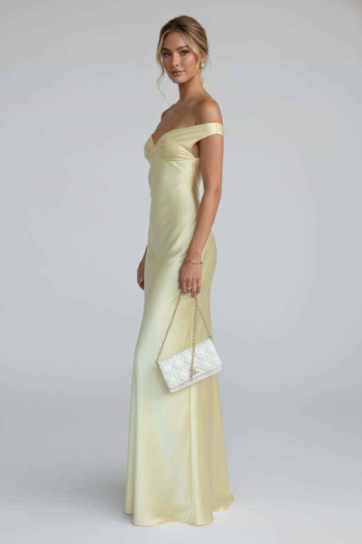 Beautiful model wearing a yellow off-shoulder maxi dress, showcasing flattering fit & elegant floor-length design.