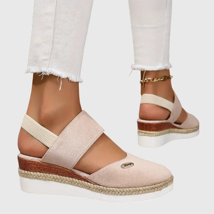 Active woman wearing ELUXOR orthopedic sandals, designed for long walks & superior arch support.